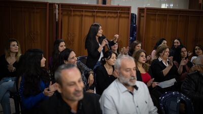 Ms Al Halabi is applauded as she poses a question to Mr Hamdan.