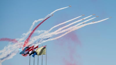 Members of the Egyptian Armed Forces, perform an aerobatic show during the inauguration of the Mohamed Naguib Military Base. Rashed Al Mansoori