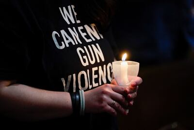 A girl holds a candle in Newtown, Connecticut, during a solidarity vigil for the Uvalde, Texas, community after a mass shooting at Robb Elementary School. Reuters