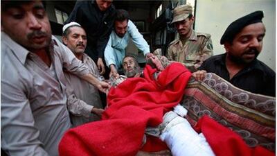 A man injured in the attack on the Pakistani military headquarters is moved to a hospital in Peshawar.