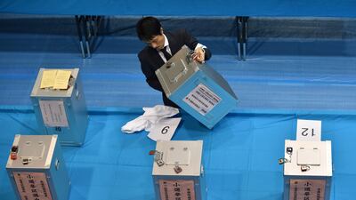 An official of the election administration committee brings a ballot box to count ballot papers for Japan's general election at an election office inTokyo on October 22, 2017. Kazuhiro Nogi / AFP