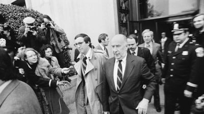 John Mitchell, one of six people charged in the Watergate scandal, walks outside US District Court in Washington on March 9, 1974, where he faced arraignment. Mitchell was eventually convicted of conspiracy, perjury and obstruction of justice related to the Watergate scandal that brought down President Richard Nixon. AP