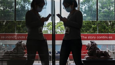 A pedestrian walks past a statue of a lion in front of the HSBC Holdings Plc headquarters building in Hong Kong. Bloomberg
