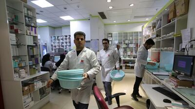 Iranian medical staff work at the state-run pharmacy in Tehran, amid reports of scarce medicine supplies in the country. AFP