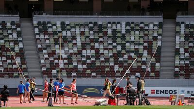 Athletes hold pole vaults at the morning session of the Athletics test event. Reuters