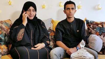 Zafaran Al Muhanna speaks on a mobile phone in Sanaa, Yemen, while she sits with her nephew, as her husband remains stuck in Egypt after flights were grounded. Reuters