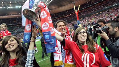 Lille's French coach Rudi Garcia celebrates with his daughters and the trophy at the end of the French Cup final against PSG on May 14, 2011, at the Stade de France in Saint-Denis, northern Paris. Lille won 1-0. AFP