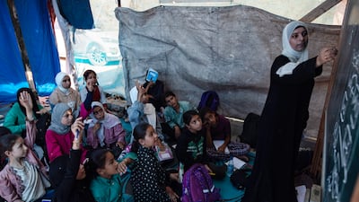 Palestinian children attending class in a tent school in the Khan Younis refugee camp in southern Gaza. EPA