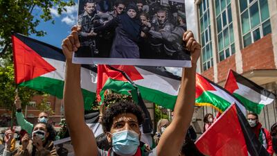 Protesters shout slogans and wave Palestinian flags in support of Palestinians outside the Israeli embassy in Madrid, Spain. AP
