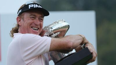 Miguel Angel Jimenez embraces the Hong Kong Open trophy on Sunday after winning the event for the fourth time in his career. Ian Walton / Getty Images