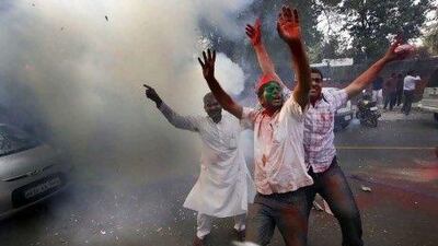 Samajwadi Party supporters celebrate their gains in five Indian state elections by burning firecrackers at their party office in New Delhi.