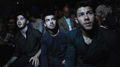 epa03853047 The US band the Jonas Brothers (Lto R) Kevin, Joe, and Nick, attend the Richard Chai Spring 2014 collection fashion show during Mercedes-Benz Fashion Week in New York, New York, USA, 05 September 2013. The Spring 2014 collections are presented from 05 to 12 September. EPA/PETER FOLEY