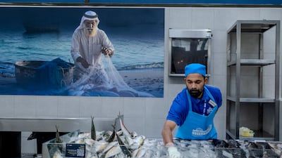 Salesmen sell fish at Al Jubail Market in Sharjah. Ahmed Ramzan / The National