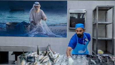 Salesmen sell fish at Al Jubail Market in Sharjah. Ahmed Ramzan / The National