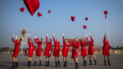 Stewardesses throw their hats up at Tiananmen Square before the closing ceremony of the 19th National Congress of the Communist Party of China (CPC) in Beijing. Roman Pilipey / EPA