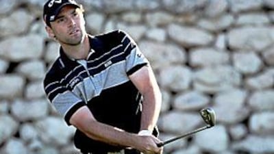 Oliver Wilson plays a chip shot on the 16th hole during the first round of the Commercialbank Qatar Masters yesterday.