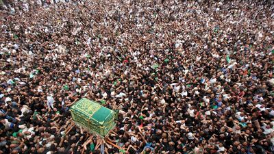 Shi'ite pilgrims carry a mock coffin during a symbolic funeral marking the anniversary passing of Imam Moussa al-Kadhim at the Imam Moussa al-Kadhim shrine in Baghdad's Kadhimiya district, Iraq. Stringer / Reuters