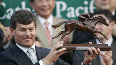 Godolphin's racing manager Simon Crisford, shown here holding the winner's trophy on the podium after winning the Hong Kong Cup race in 2007, has resigned as racing manager of the Godolphin stable. Victor Fraile / Reuters