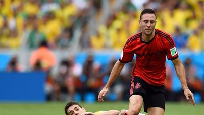 Oscar of Brazil tackles Miguel Layun of Mexico during their match on Tuesday at the 2014 World Cup in Fortaleza, Brazil. Buda Mendes / Getty Images