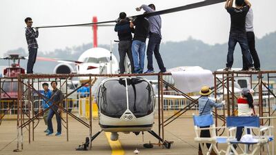 Workers install a propeller on to a helicopter ahead of the 10th China International Aviation and Aerospace Exhibition in Zhuhai, Guangdong province, on November 10, 2014. More than 130 planes will attend the six-day air show. Alex Lee / Reuters