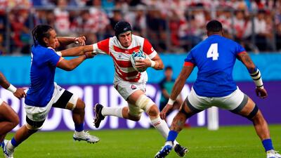Japan lock Wimpie van der Walt, centre, tried to evade Samoa flanker TJ Ioane, left, and lock Piula Faasalele. AFP