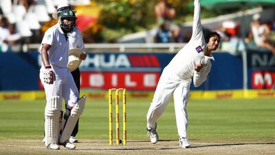 Hashim Amla, left, of South Africa backs up as Saeed Ajmal of Pakistan sends down a delivery during Day 4 of the second Test match at Newlands on February 17, 2013, in Cape Town, South Africa. Shaun Roy / Getty Images