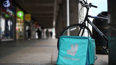 A Deliveroo bag and bike are parked near Victoria Station in central London. The group said it benefited from further strength in its key UK business, where orders increased by 72 per cent. AFP