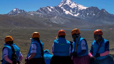 Aymara indigenous women climbers before tackling Huayna Potosi, in the background.