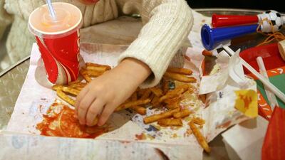 A girl enjoys food from Popeyes at Abu Dhabi Mall. Sammy Dallal / The National