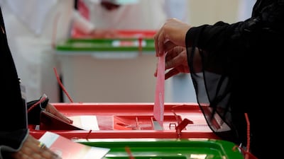 A Bahraini voter casts her ballot at a polling station in Al Muharraq, a city north of Manama. AFP