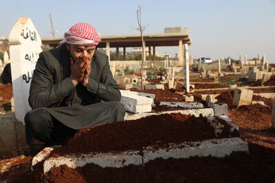 Mohammad Al Mahmoud, father of a seven-day-old baby Fatima, at her grave in Haranbush village in Idlib province, Syria. AP