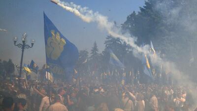A smoke grenade is thrown towards police during a clash between protesters and police after a vote to give greater powers to the east in front of the Parliament in Kiev, Ukraine. Efrem Lukatsky / AP Photo