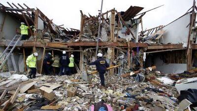 Firefighters sift through the debris of an apartment destroyed by an explosion at a fertiliser plant in West, Texas.