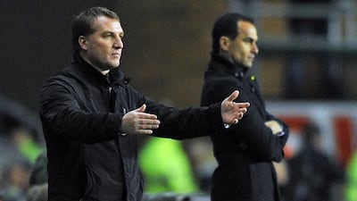 Brendan Rodgers has Liverpool in ninth so far this season, while Roberto Martinez has led Everton to fifth. Paul Ellis / AFP