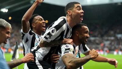Wilson, right, celebrates scoring the first goal of the game from the penalty spot. AP