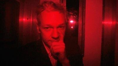 Julian Assange arrives at Westminster Magistrates Court inside a prison van with red windows.