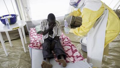 A nurse attends a new arrival in Sierra Leone.