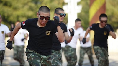 Chinese paramilitary soldiers dancing to Xiao Ping Guo - a song apparently so catchy that it has won over the army and police. China Out / AFP