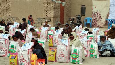 People receive food rations distributed by the Afghan Charity Foundation in Kandahar. EPA