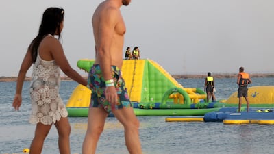 Beachgoers play at a floating blow-up water park at Pure Beach in King Abdullah Economic City.