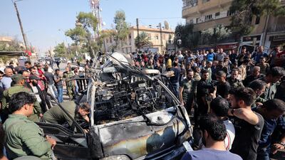 Members of the Syrian regime inspect the location where a car bomb exploded in the northeastern Syrian town of Qamishli which is mainly controlled by Kurdish forces, Syria. REUTERS