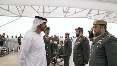 Sheikh Mohammed bin Zayed, awards a member of the UAE Armed Forces with a Medal of Bravery for his service in Yemen. Mohammed Al Hammadi / Crown Prince Court.