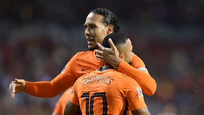 Netherlands' Memphis Depay celebrates with Virgil van Dijk after scoring against Belgium. AFP