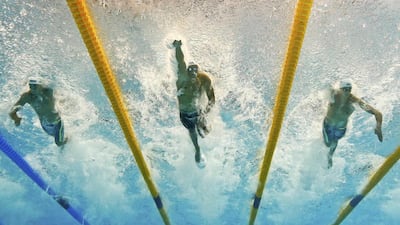 Florent Manadou, centre, of France swims in the men’s 50m freestyle semi-final at the Aquatics World Championships in Kazan, Russia August 7, 2015. Michael Dalder / Reuters