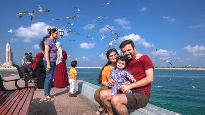 Kamlesh Unadkat's family pose for a picture at the UAE flag area. Victor Besa / The National