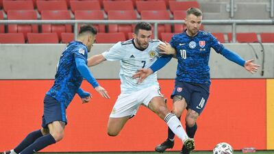 Scotland’s John McGinn battles for the ball with Slovakia’s Albert Rusnak. Reuters