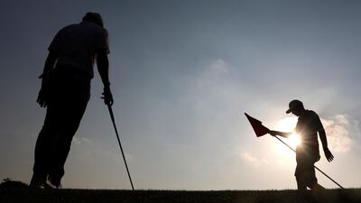 Rory McIlroy, left, alongside his caddy during the final round of the HSBC World Golf Championships in Shanghai on Sunday, November 3. The Northern Irishman won the tournament after beating Xander Schauffele in a play-off. EPA