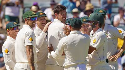 Australia's paceman Mitchell Starc, centre, celebrates with teammates after taking the wicket Martin Guptill during day two of the second Test match between Australia and New Zealand in Perth on November 14, 2015. AFP PHOTO/Tony ASHBY.