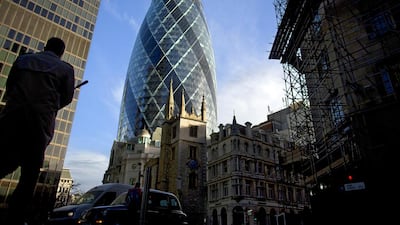 A pedestrian and vehicles pass 30 St Mary Axe, also known as The Gherkin, in London. Simon Dawson / Bloomberg