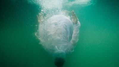 Tourists recreate the traditional pearl diving experience where visitors get to experience life and diving for pearls on a traditional pearl dhow, near the Jebel Ali Palm. Antonie Robertson / The National